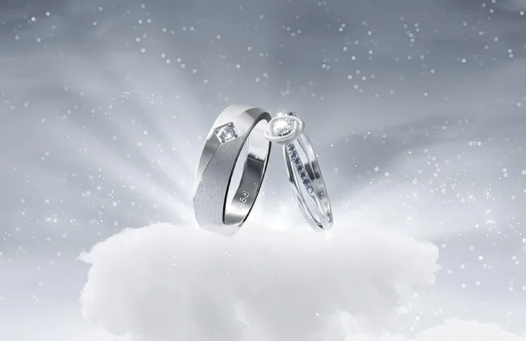 Two platinum wedding rings engraved with Blissful Balance